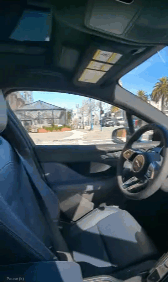Waymo self-driving vehicle turning autonomously at a green light